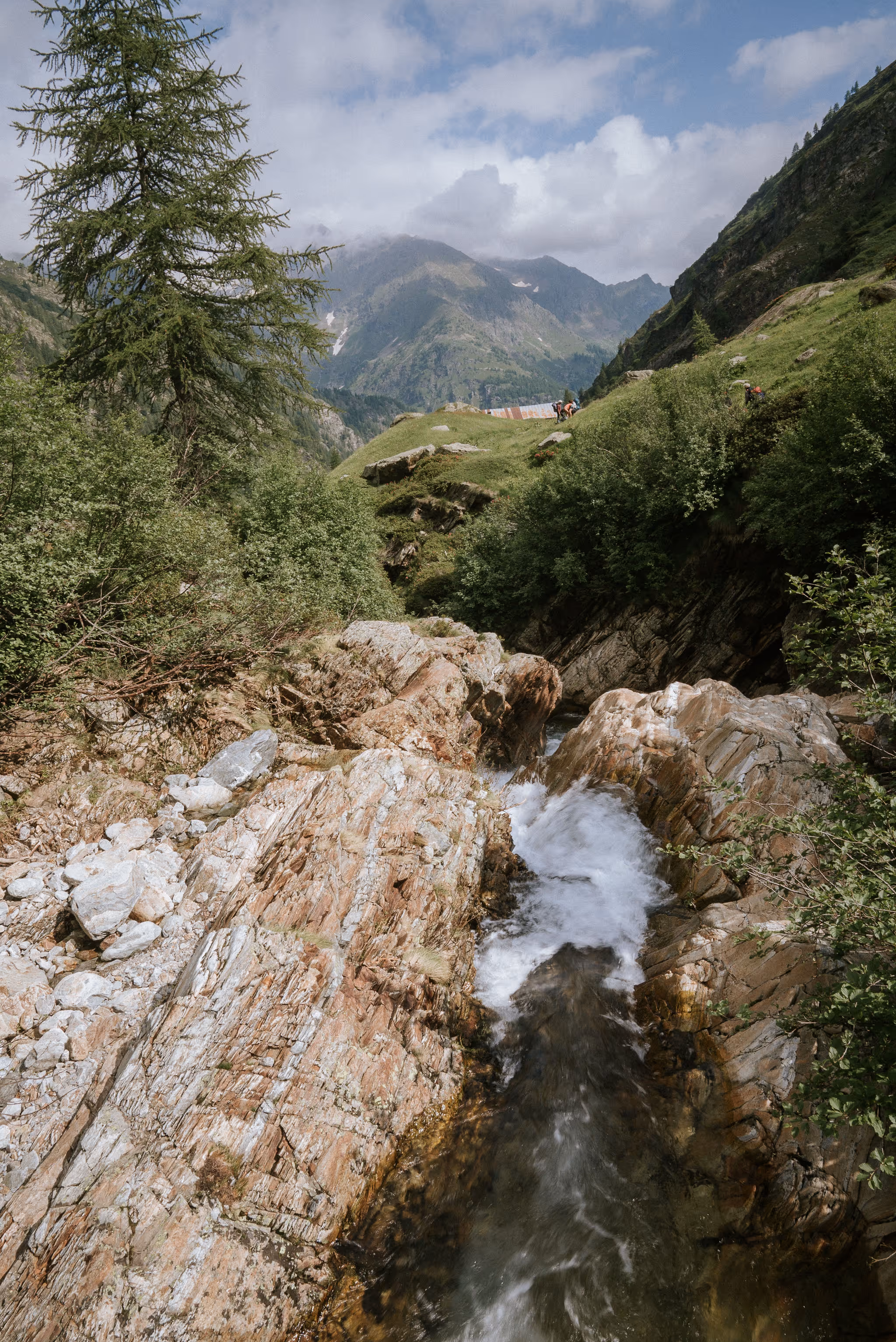 A walker standing still in a wide alpine landscape