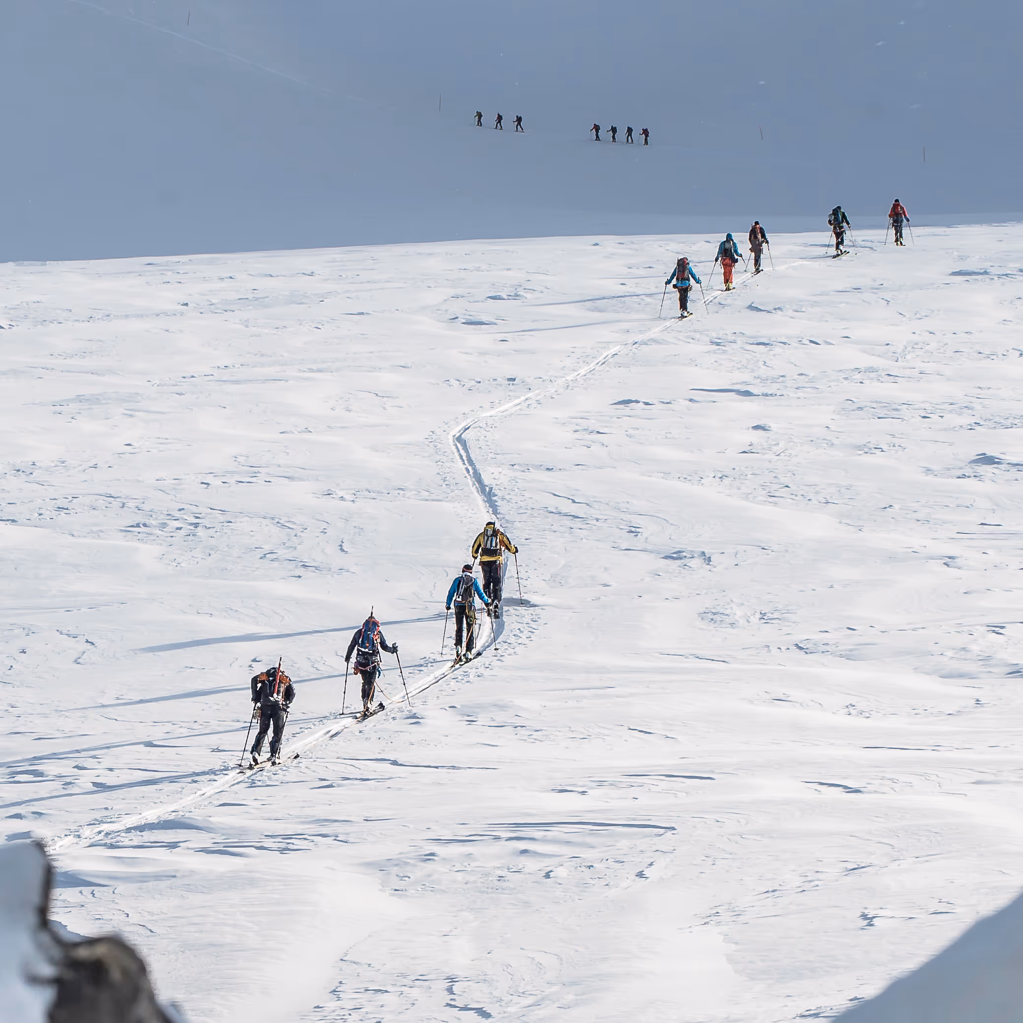 Ski tourers ascending a snow slope in the Alps
