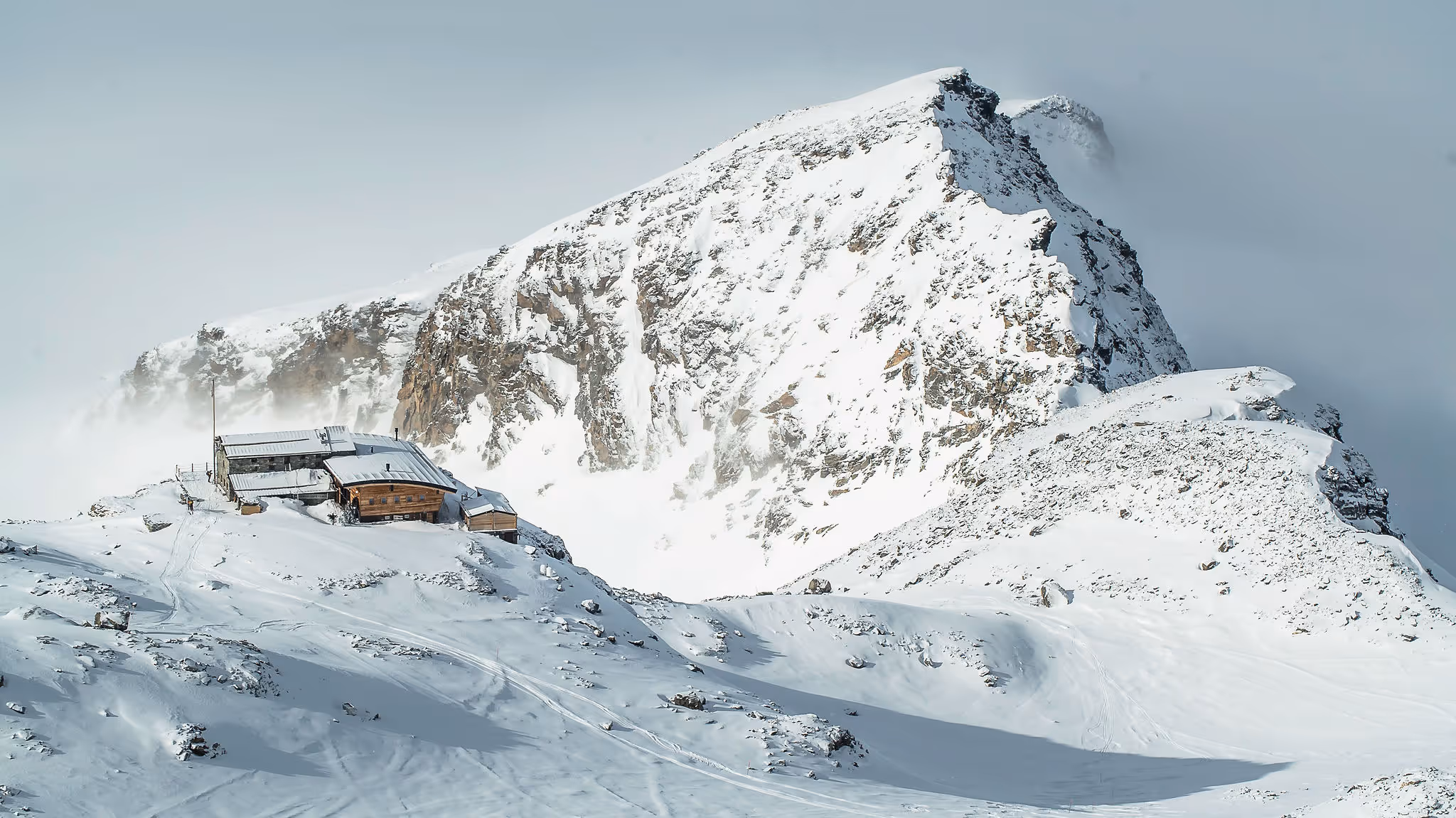 A skier breaking trail across an untouched slope